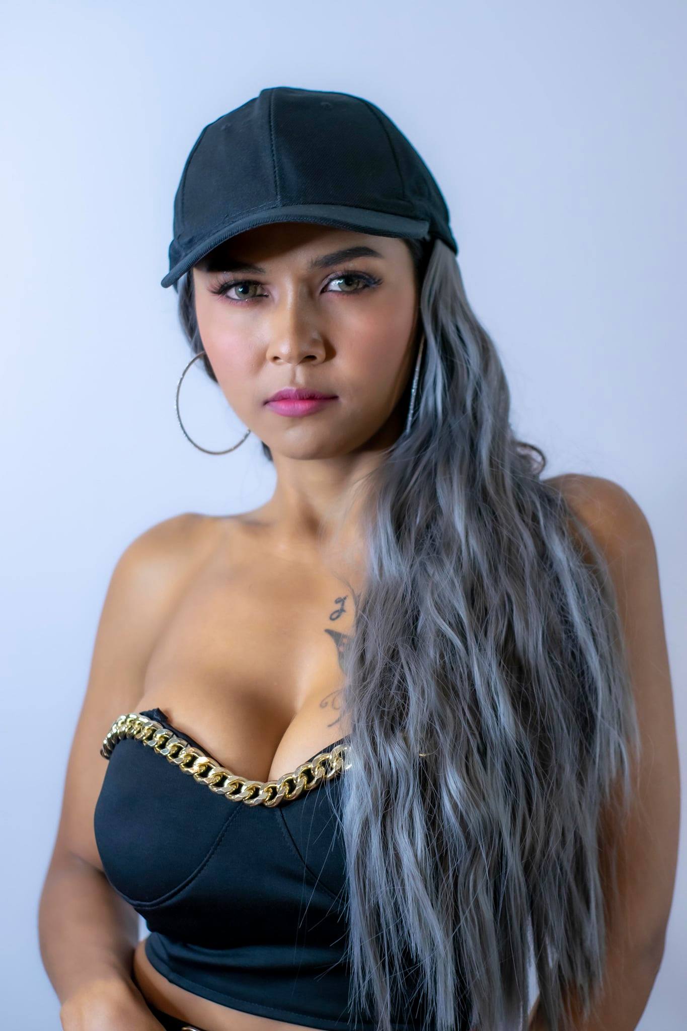 Mean looking asian girl wearing a cap