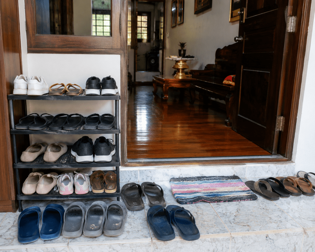Removing shoes before entering homes and temples in Thailand